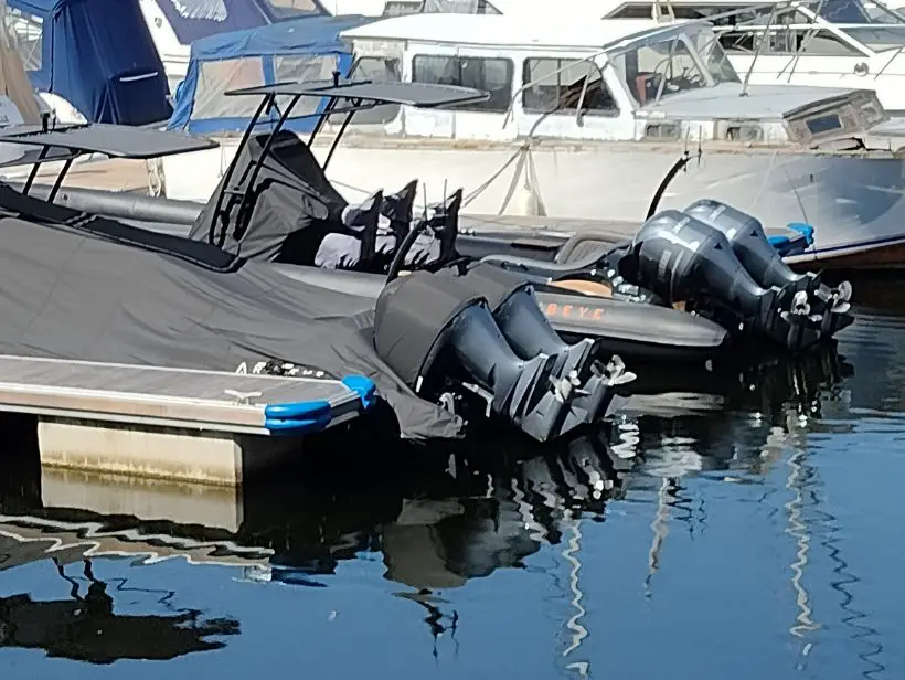 boats in the marina with outboard motors out of the water